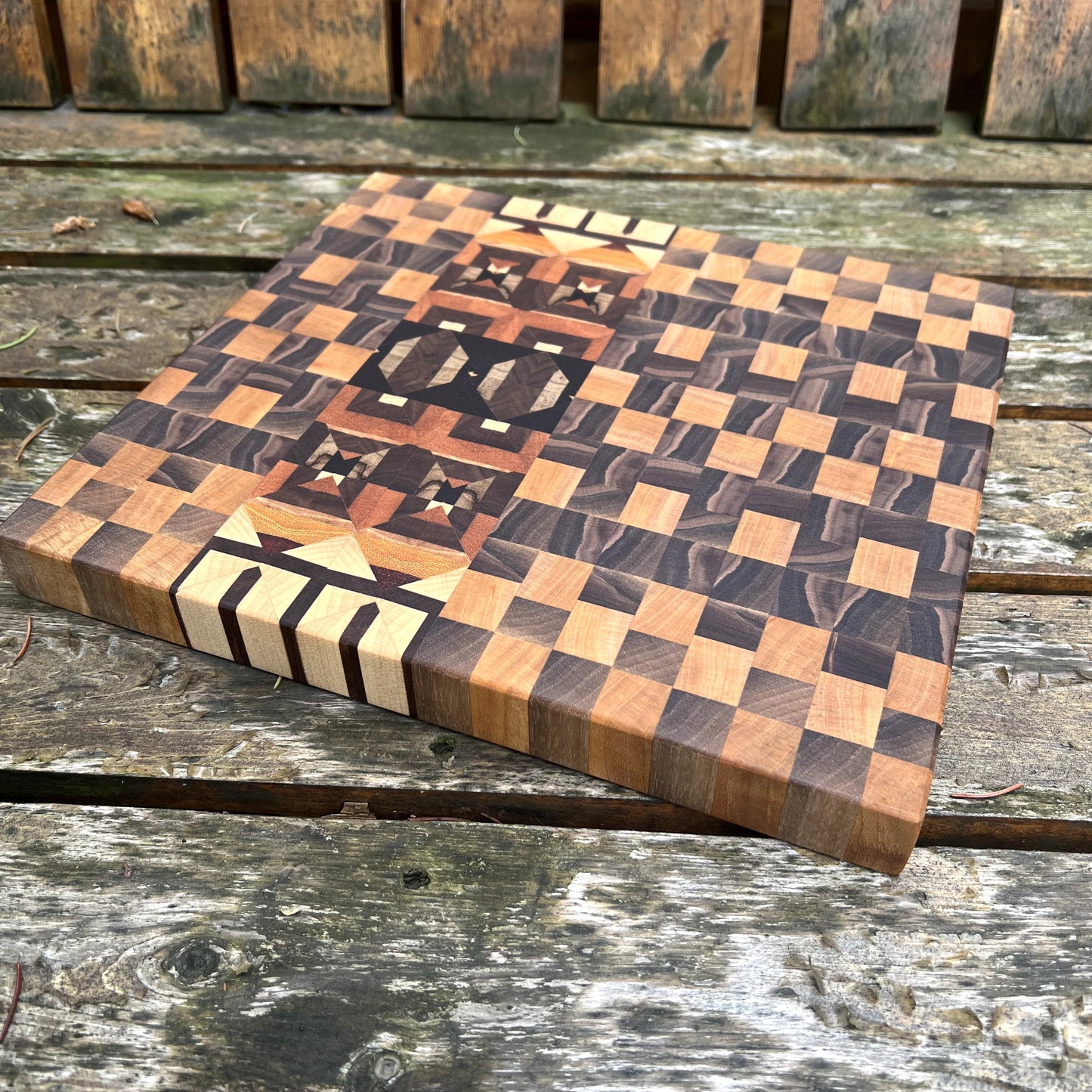Wooden cutting board with checkered pattern on a wooden surface