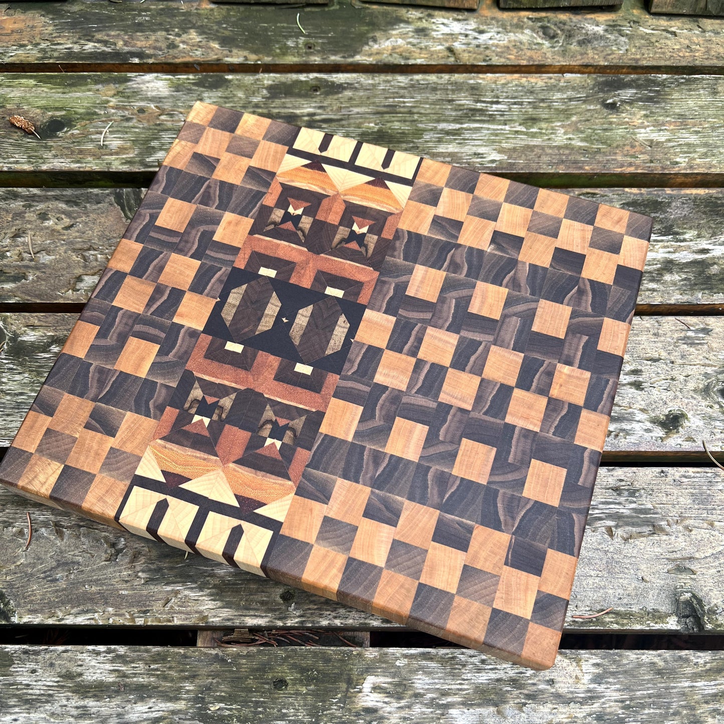 Wooden cutting board with checkered pattern on a wooden surface