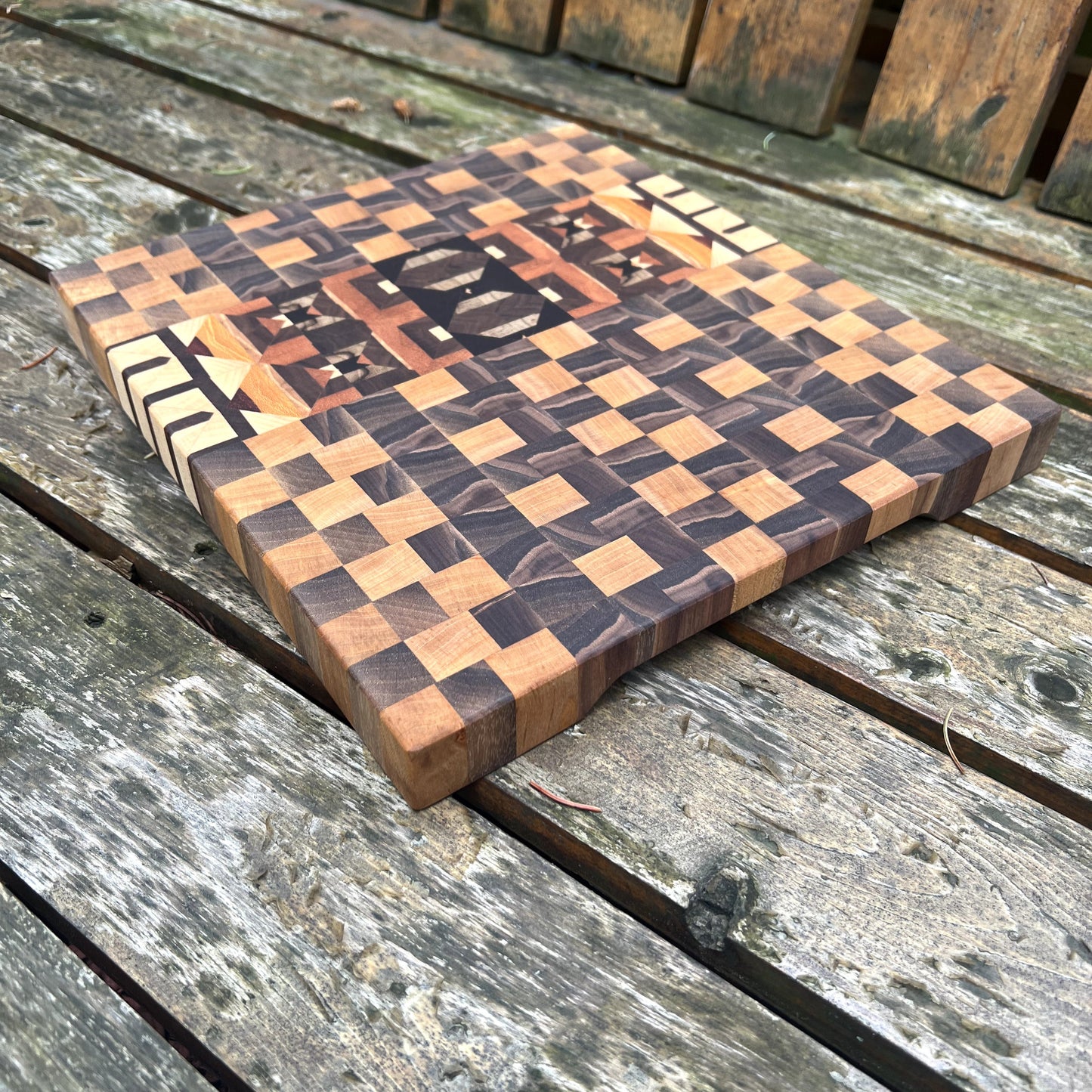 Wooden cutting board with checkered pattern on a wooden surface