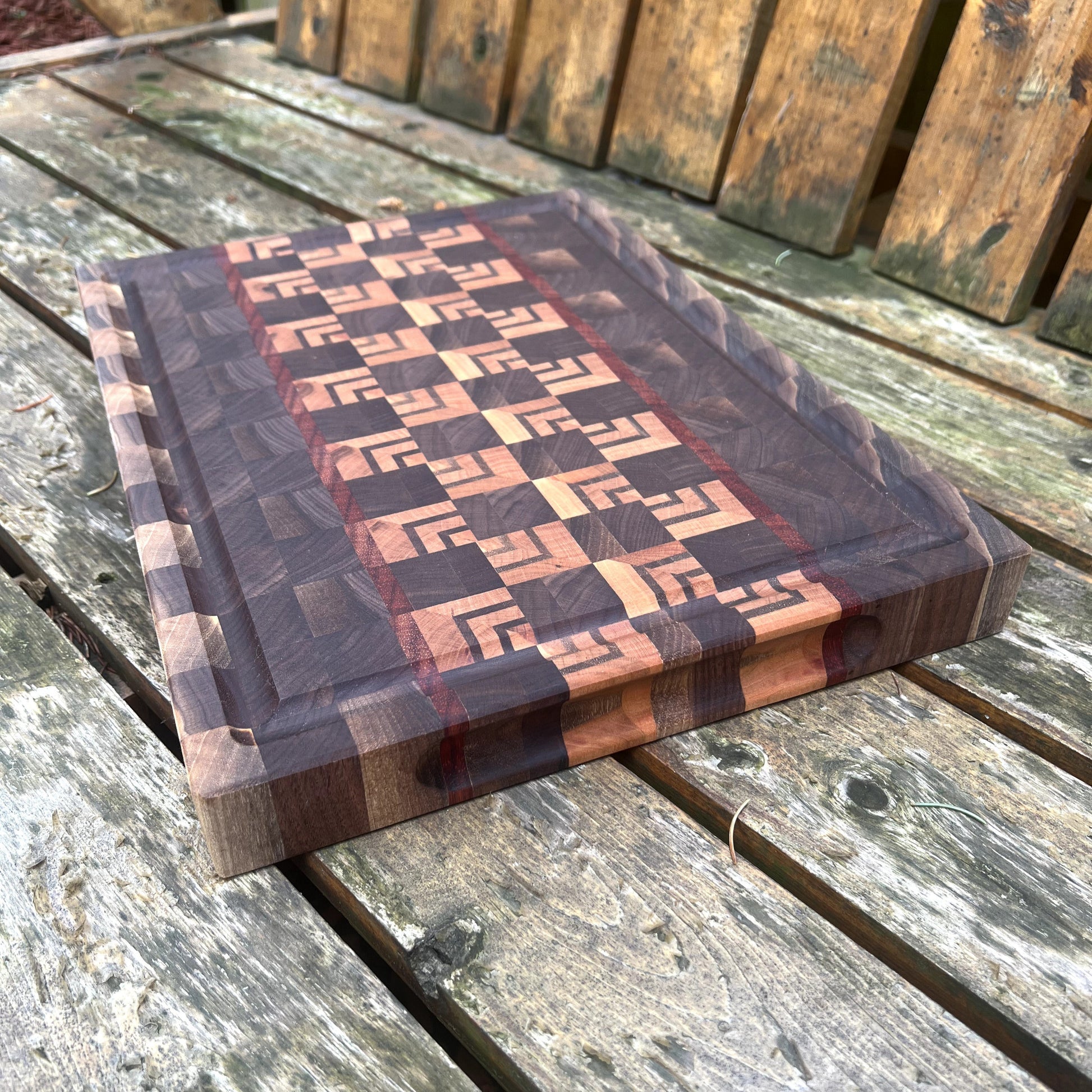 Wooden cutting board with geometric pattern on a wooden surface