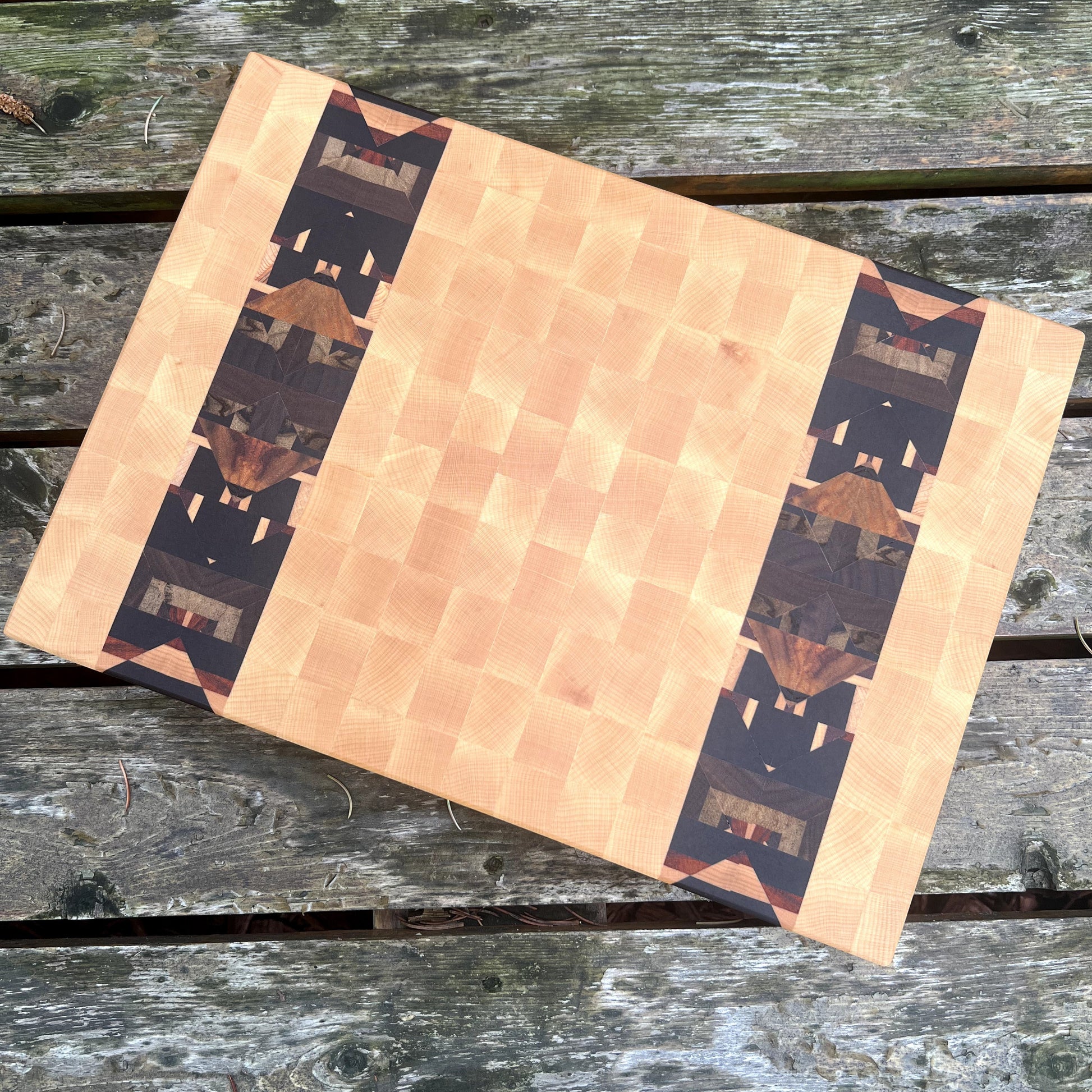 Wooden cutting board with wavy pattern on a wooden surface