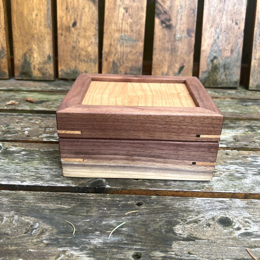 Wooden jewelry box on a rustic wooden surface