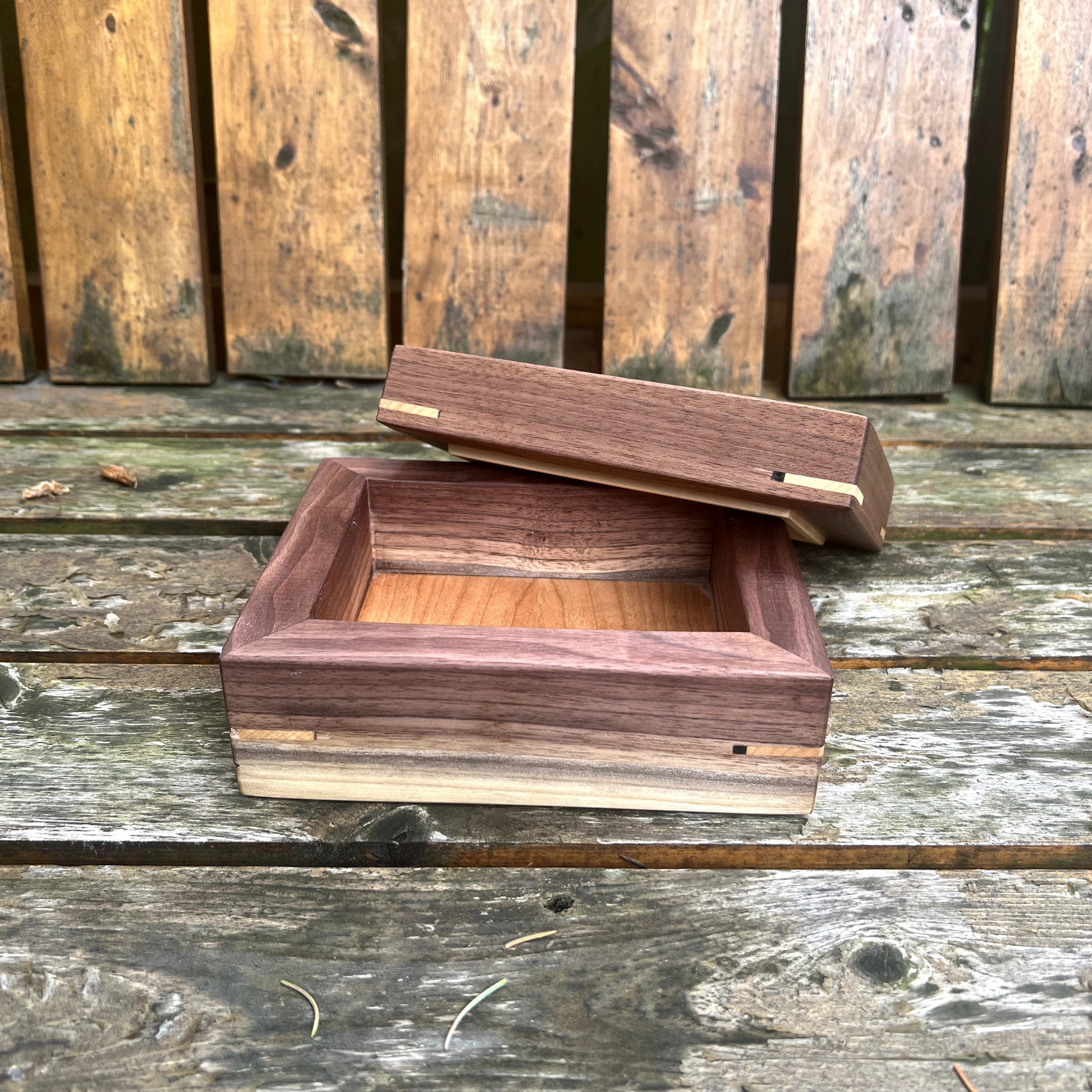 Wooden box with a lid on a wooden surface