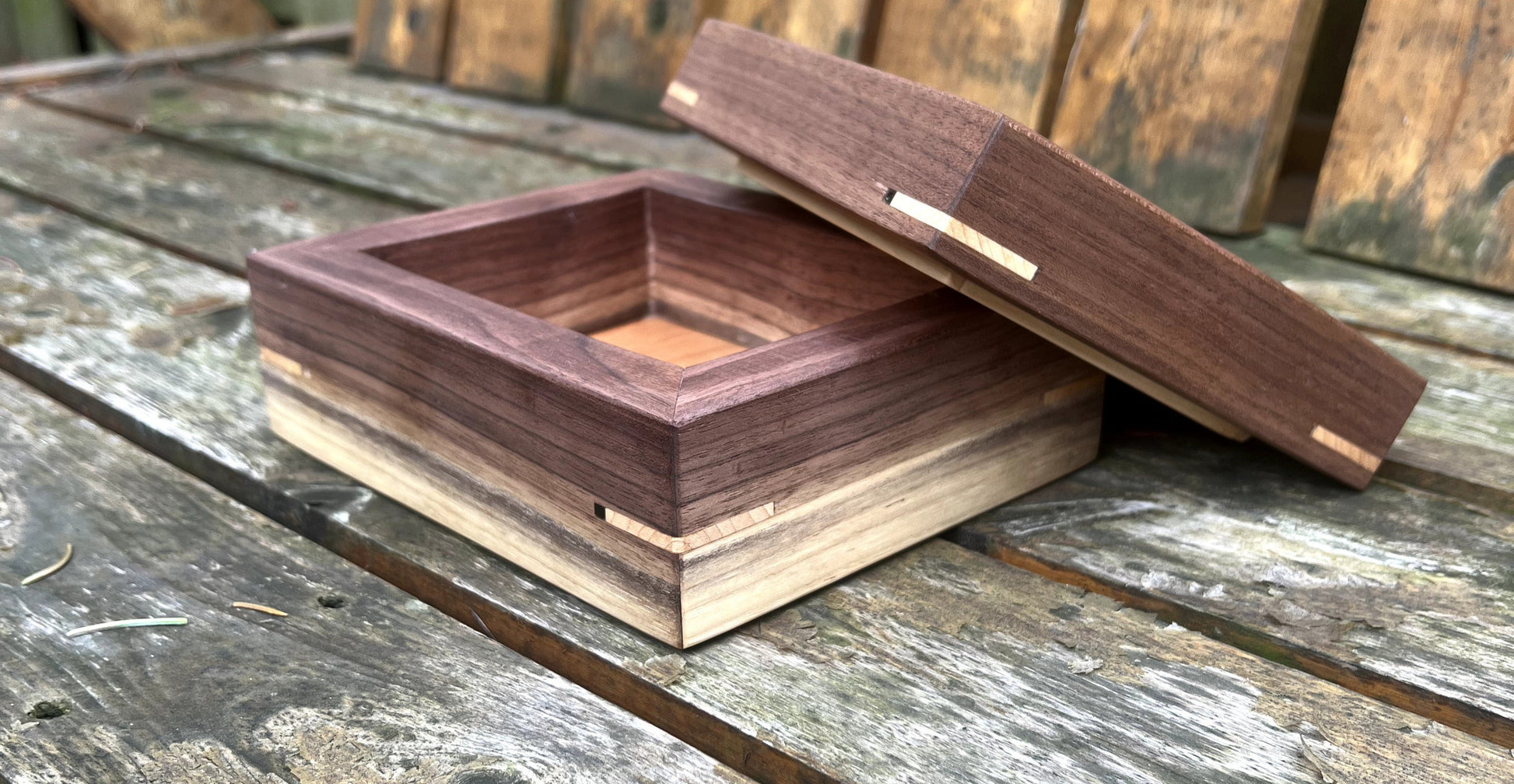 Wooden box with a lid on a wooden surface