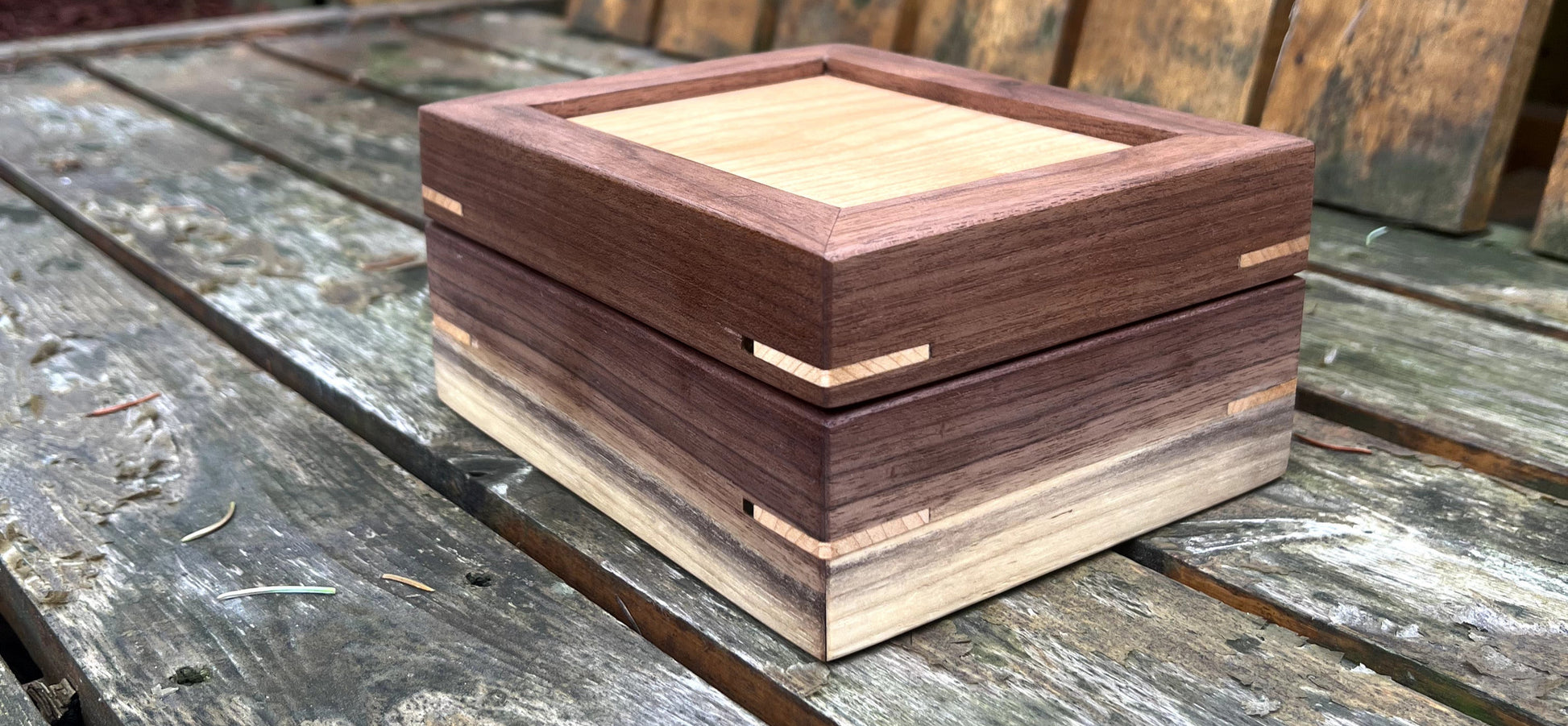 Wooden jewelry box on a wooden surface outdoors
