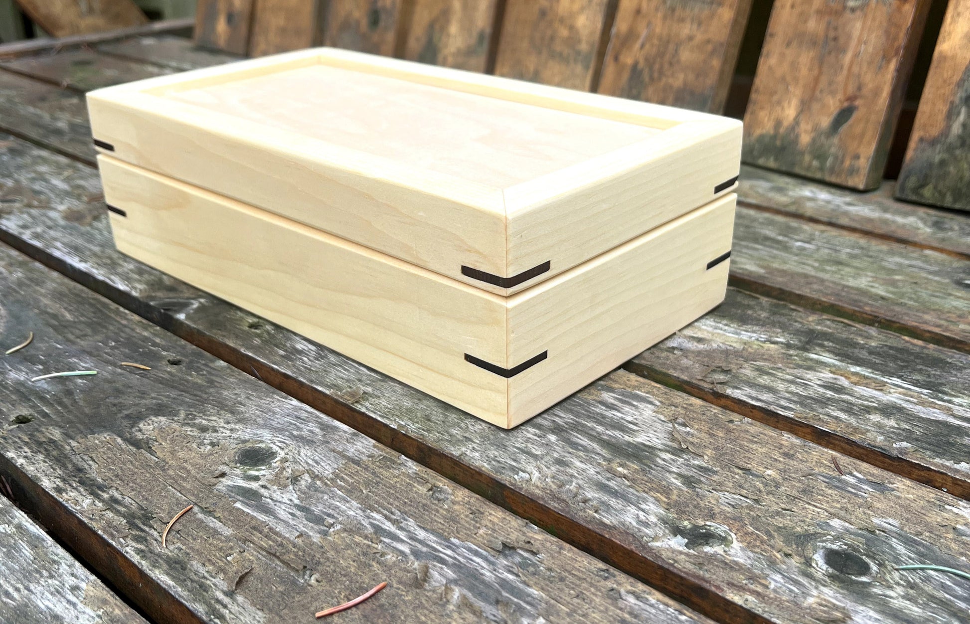 Stack of beige wooden boxes on a wooden surface
