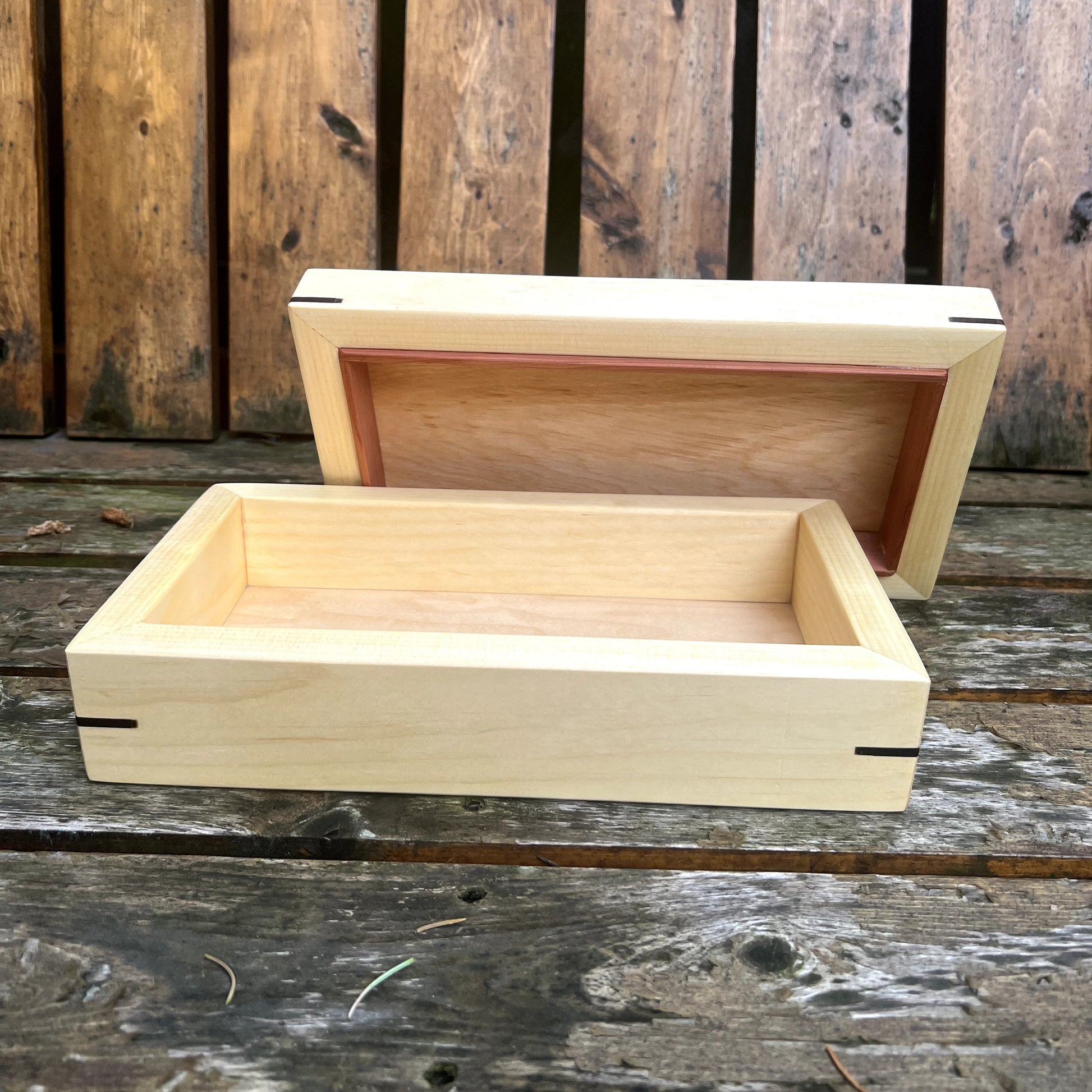 Wooden box with lid on a rustic wooden surface