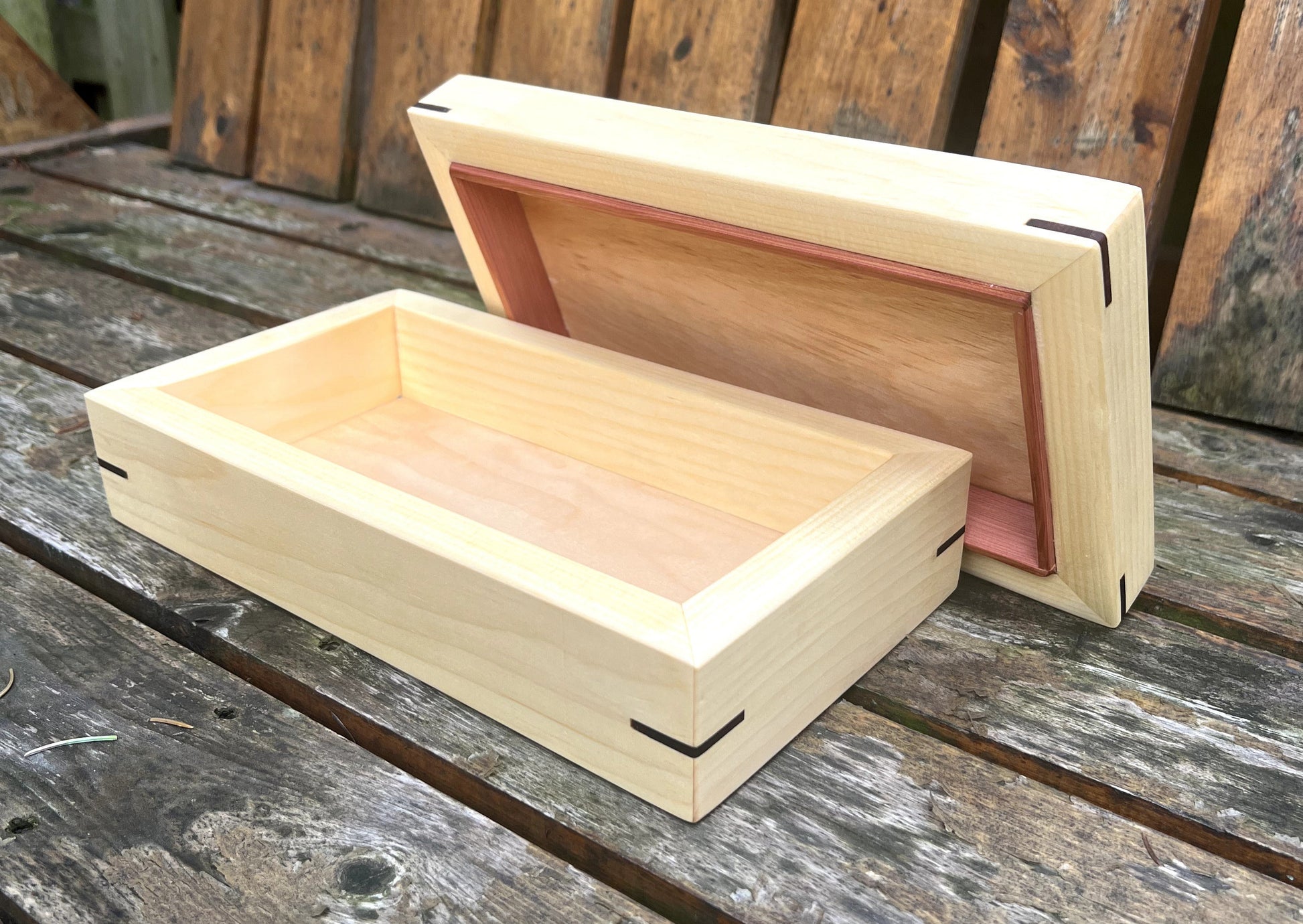 Wooden box with a lid on a wooden surface