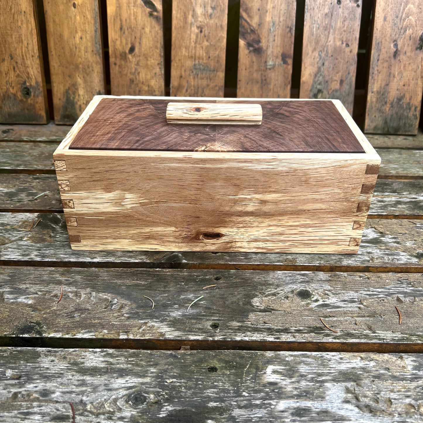 Wooden box with a lid on a wooden surface