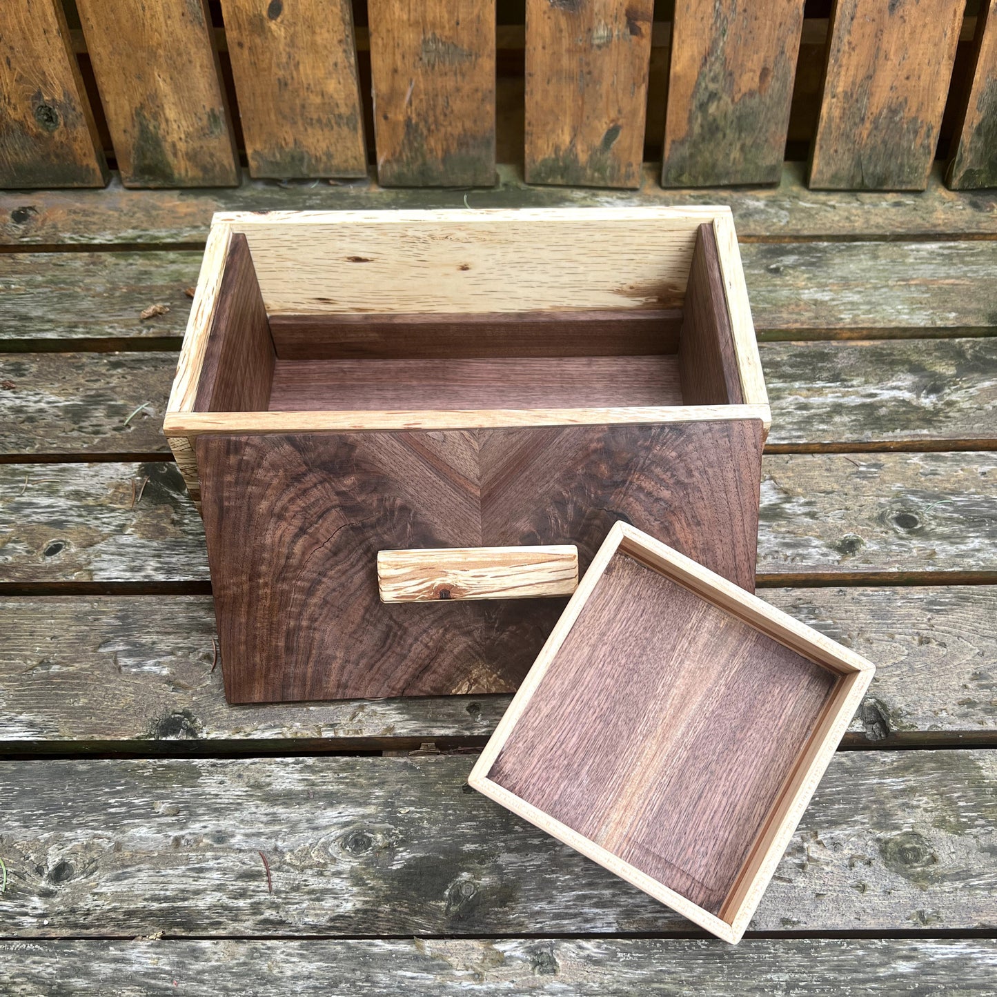 Wooden box with a lid on a wooden surface