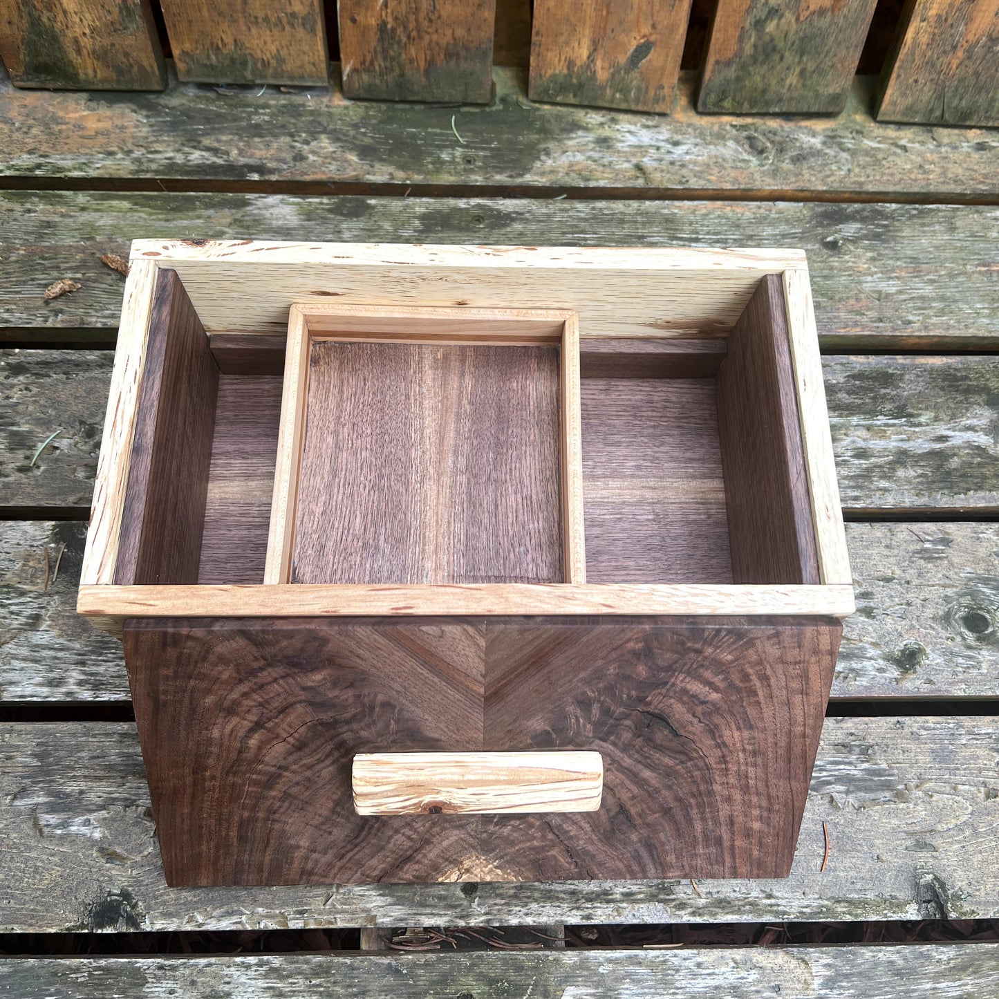Wooden box with compartments on a wooden surface
