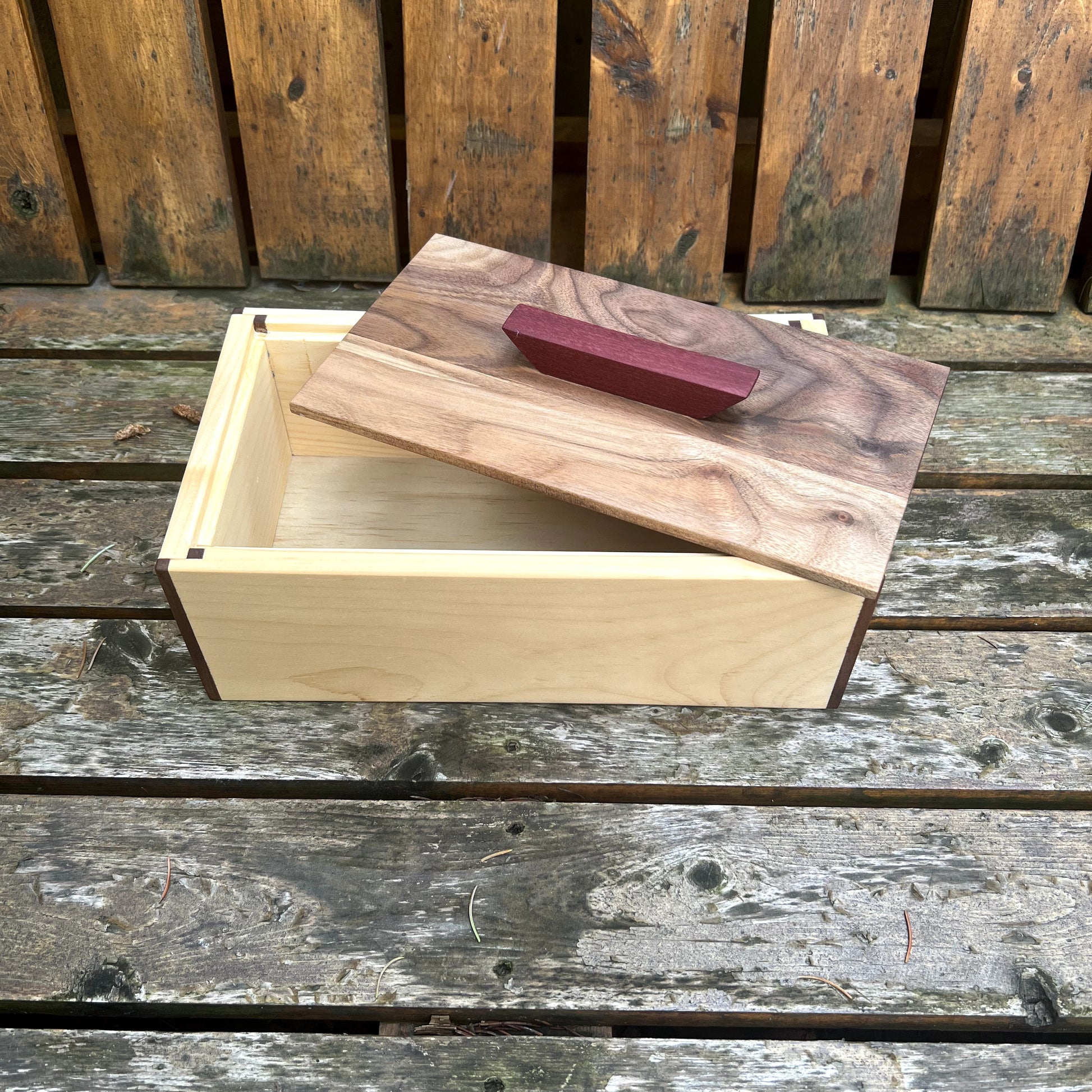 Wooden box with a lid on a wooden surface