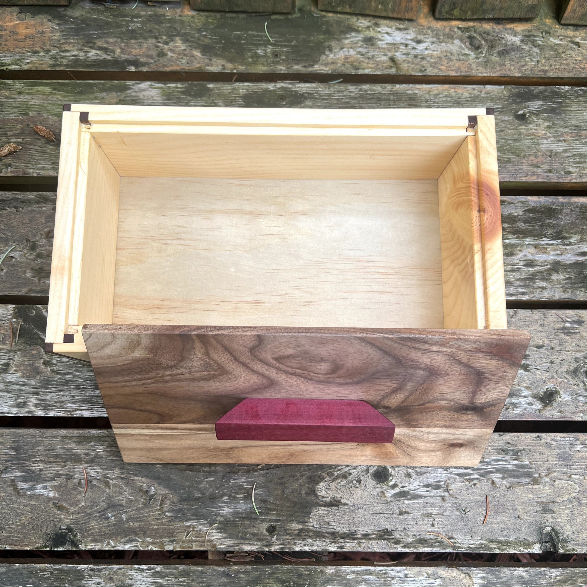 Wooden crate with a purple label on a wooden surface
