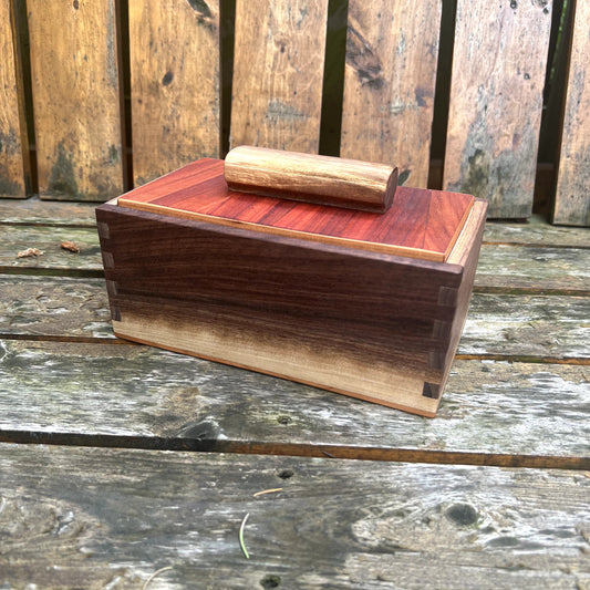 Wooden box with a lid on a wooden surface