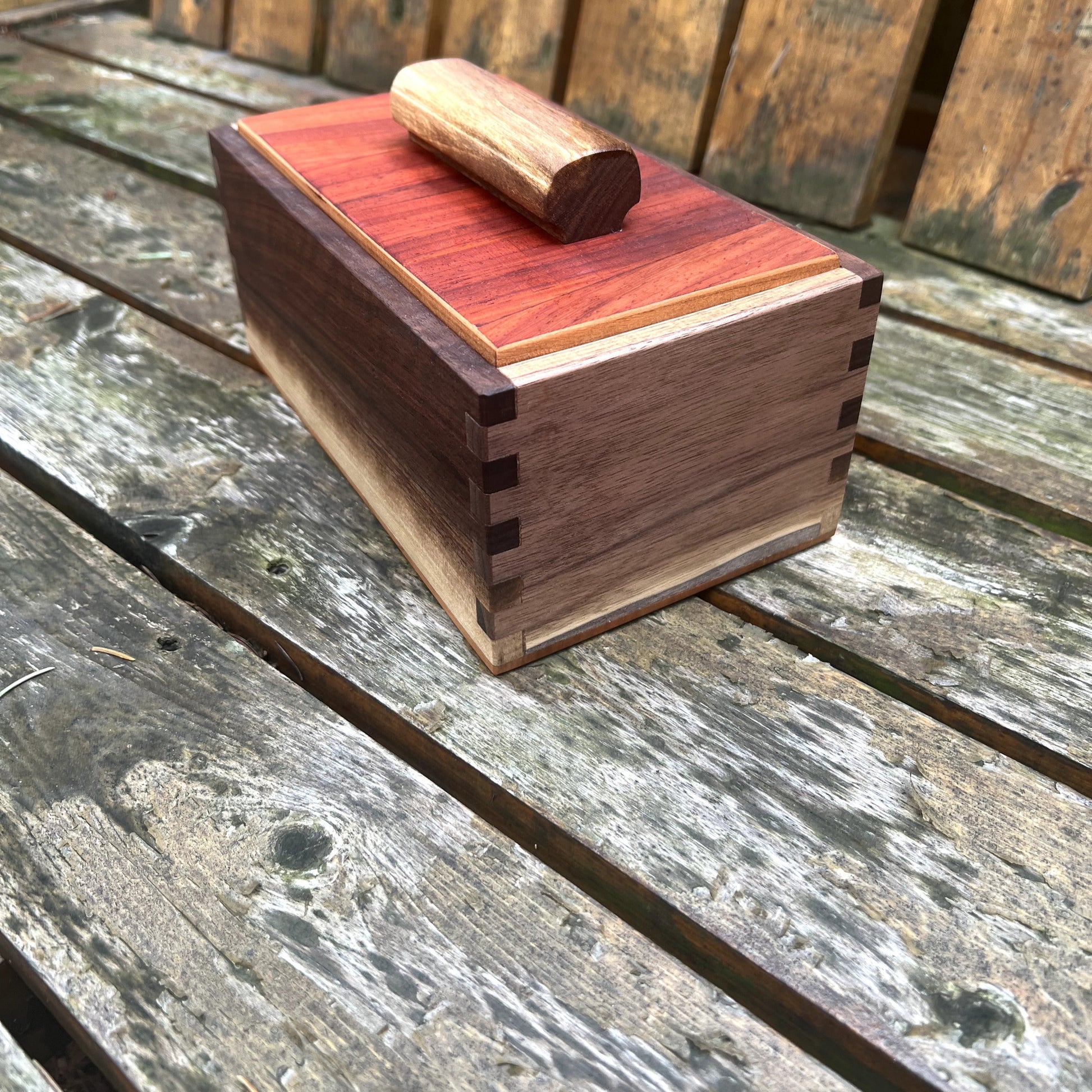 Wooden box with a lid on a wooden surface