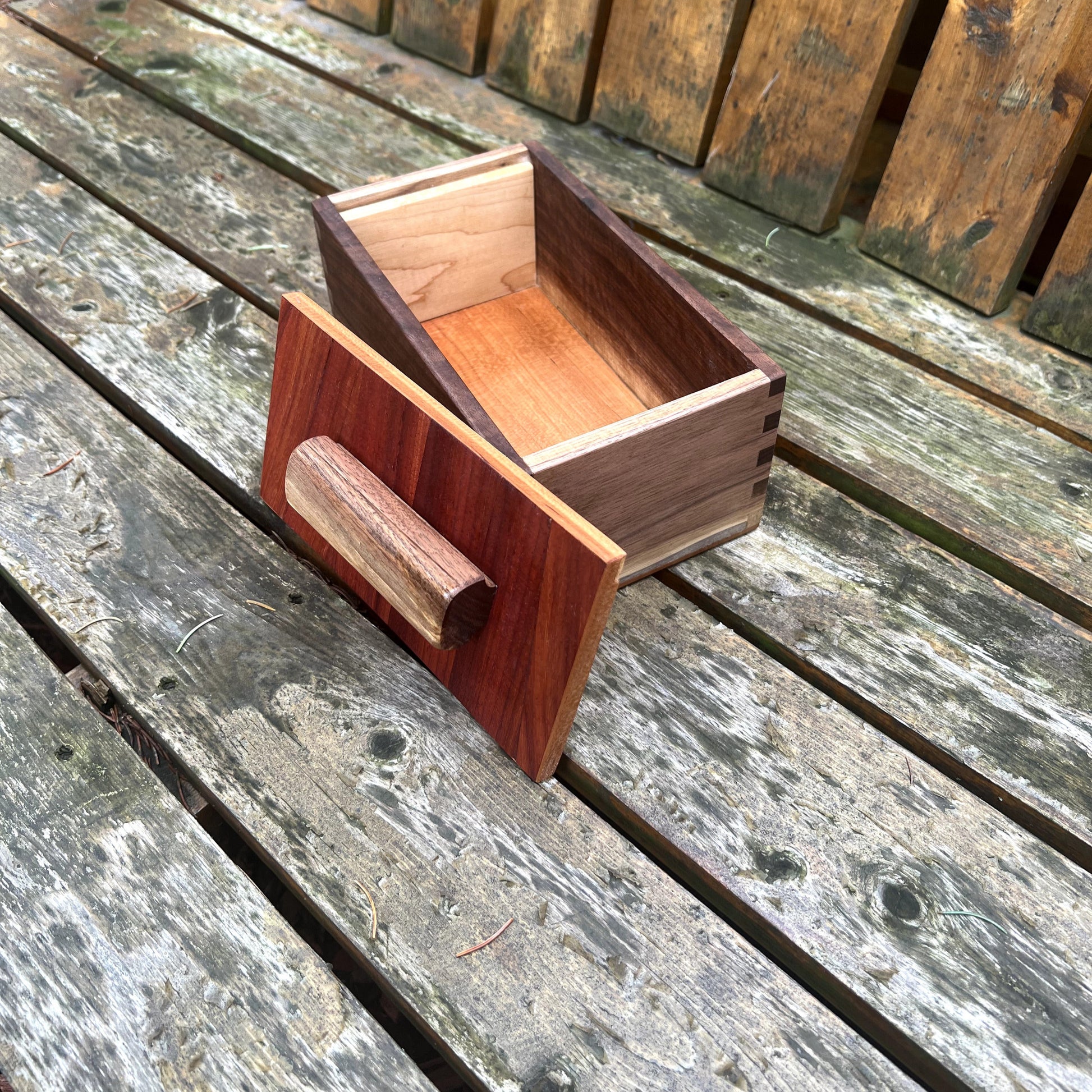 Wooden box with a handle on a wooden surface