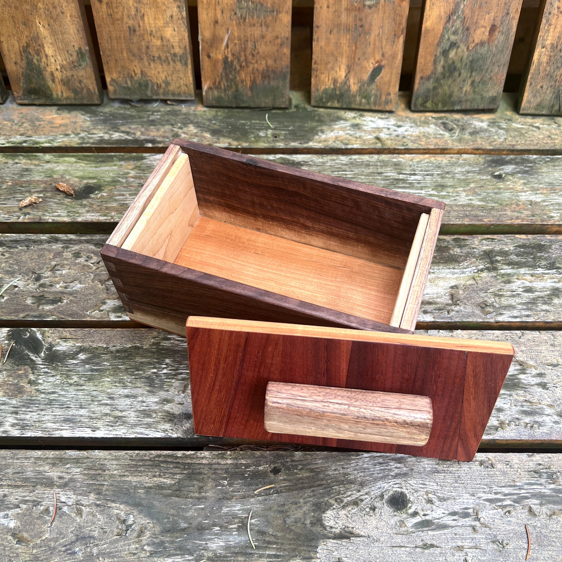 Wooden box with a lid on a wooden surface