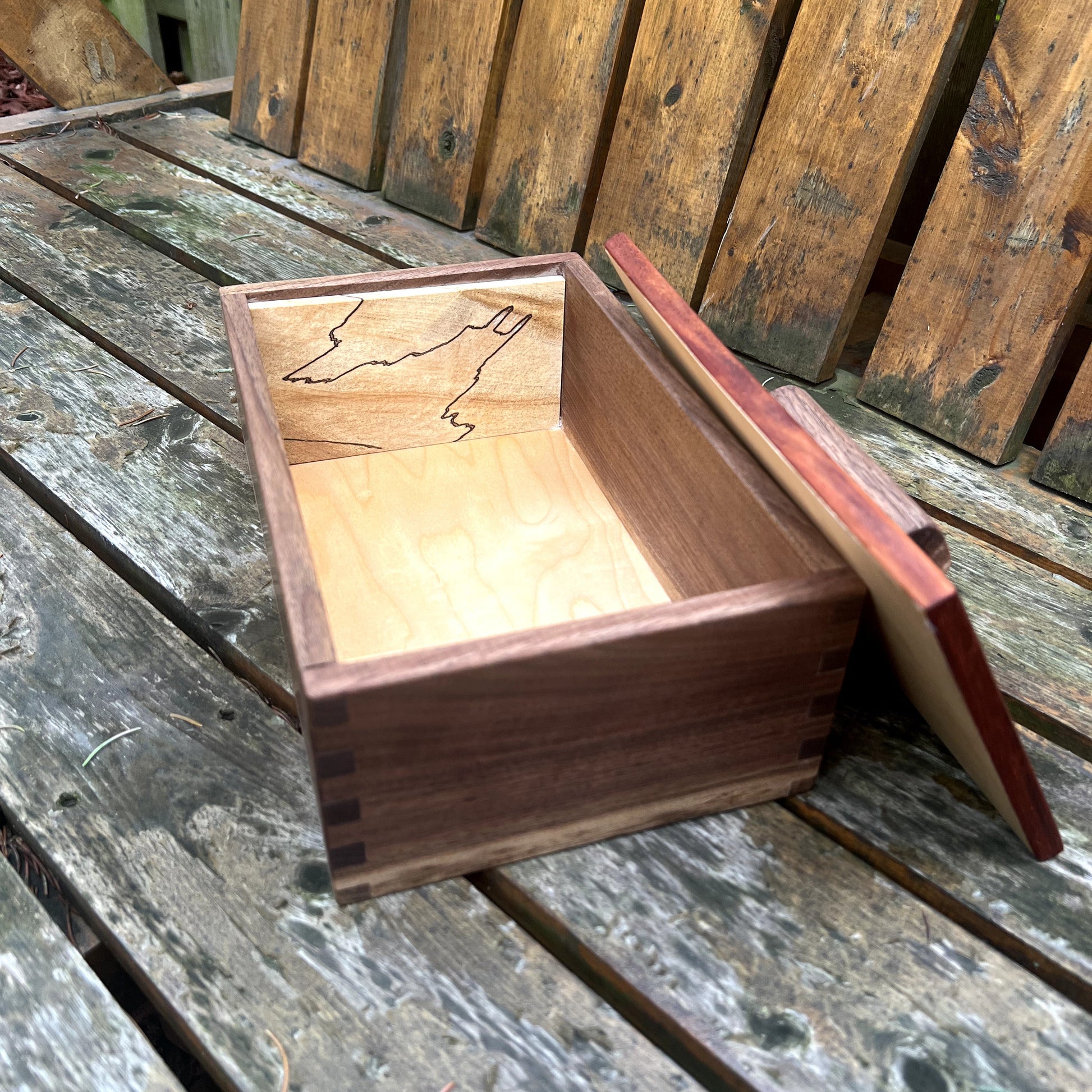 Wooden box with a lid on a wooden surface
