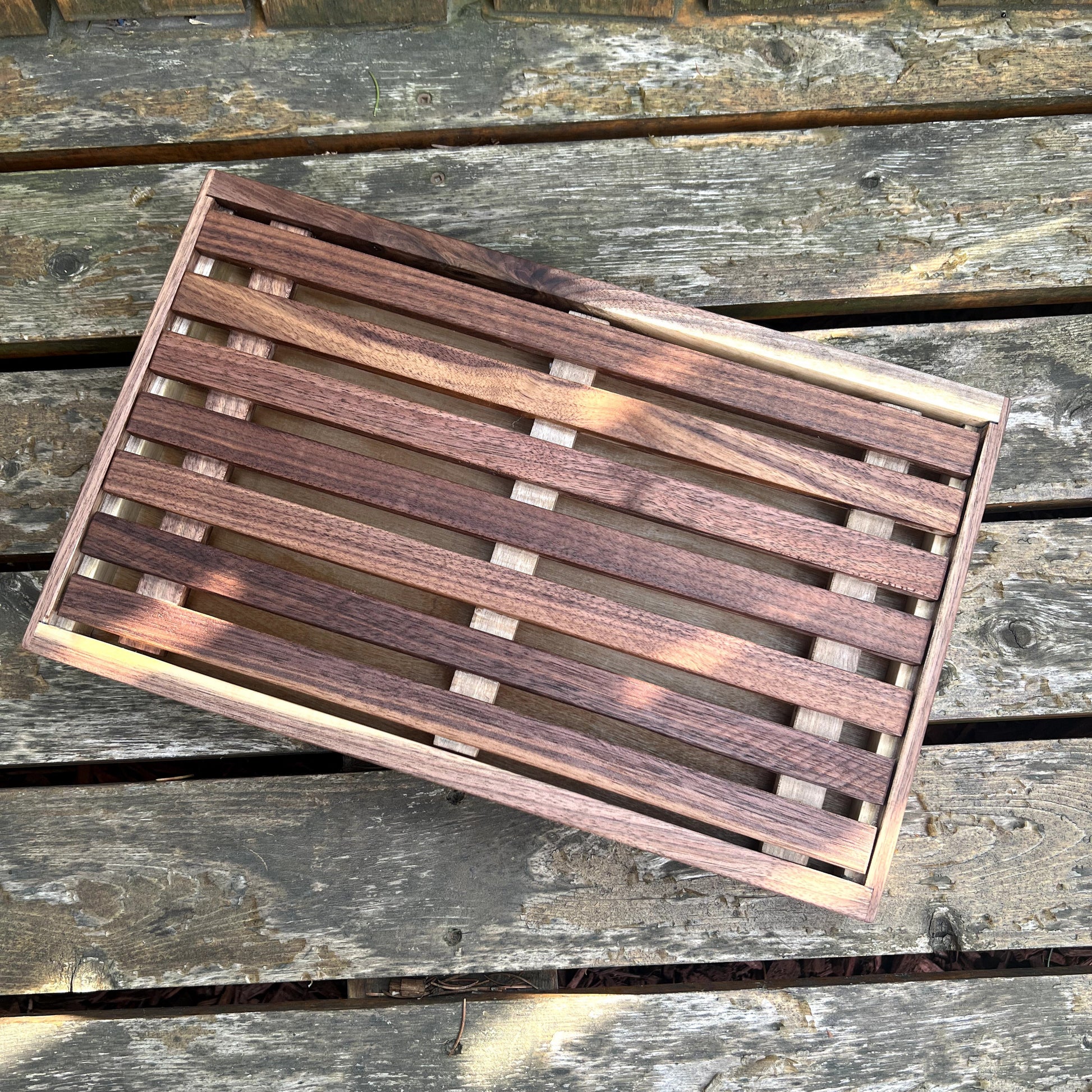 Wooden slatted mat on a wooden surface