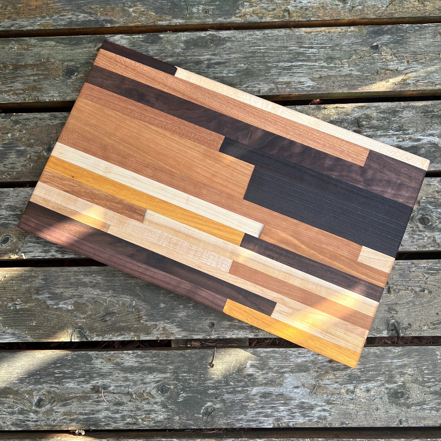 Wooden cutting board with a striped pattern on a wooden surface