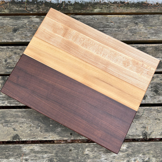 “Scandinavian-style cutting board with roasted maple and cherry contrast — The Reykjavík by Shamrock Designs.”