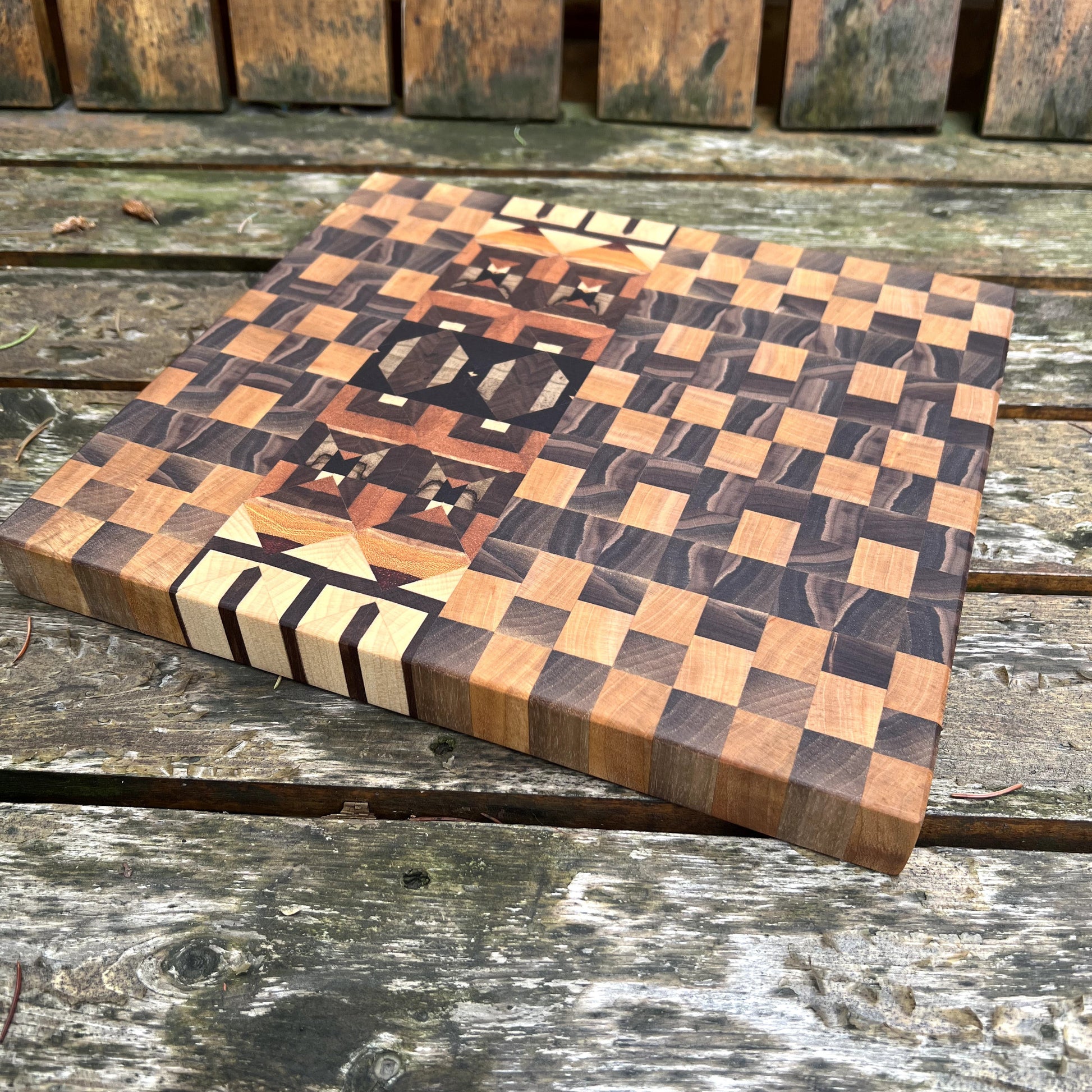 Wooden cutting board with checkered pattern on a wooden surface