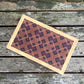 Rectangular mat with geometric pattern on a wooden surface