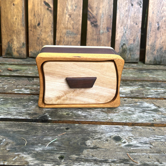 Wooden box with a handle on a wooden surface