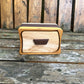 Wooden box with a handle on a wooden surface
