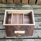Wooden box with compartments on a wooden surface