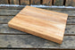 “Maple and cherry Scandinavian-style cutting board with clean grain lines — The Nordic by Shamrock Designs.”