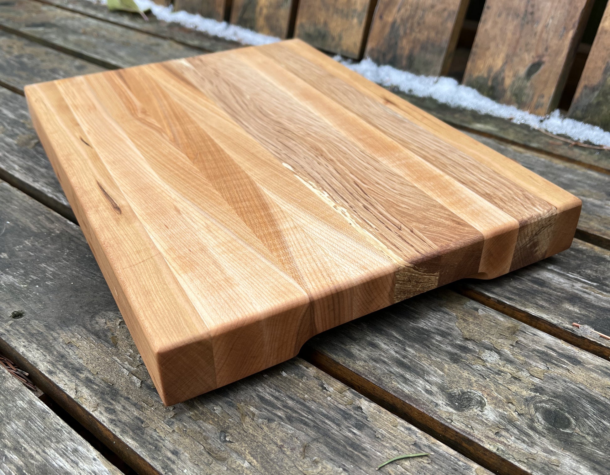 “Close-up of handcrafted maple and cherry grain on The Nordic cutting board.”