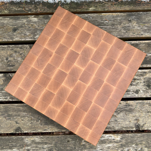 “The Alpine Block — handcrafted end-grain maple cutting board with geometric pattern, 12.25x12.25x1.75 inches.”