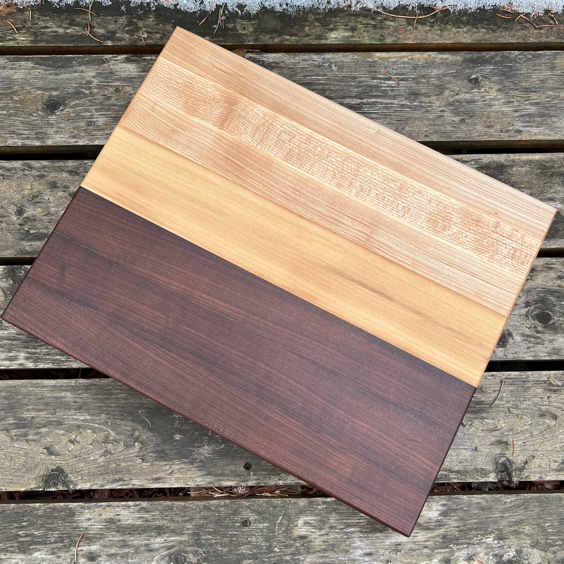 “Scandinavian-style cutting board with roasted maple and cherry contrast — The Reykjavík by Shamrock Designs.”